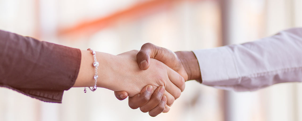 Woman shaking a man's hand