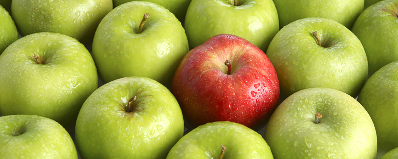 Green apples with one red apple in the middle