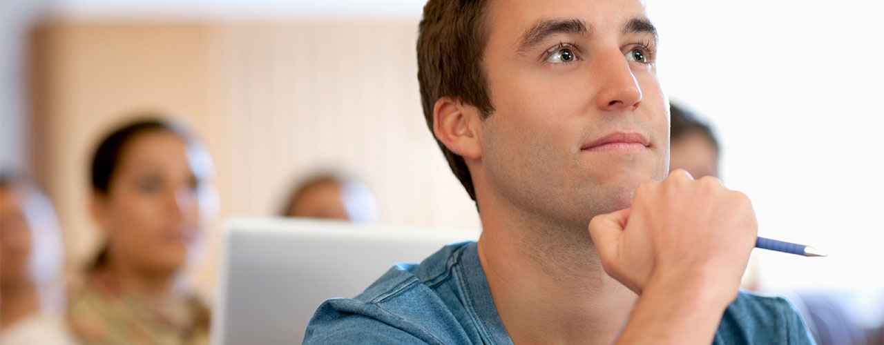 Close up of an undergraduate male student with others in background